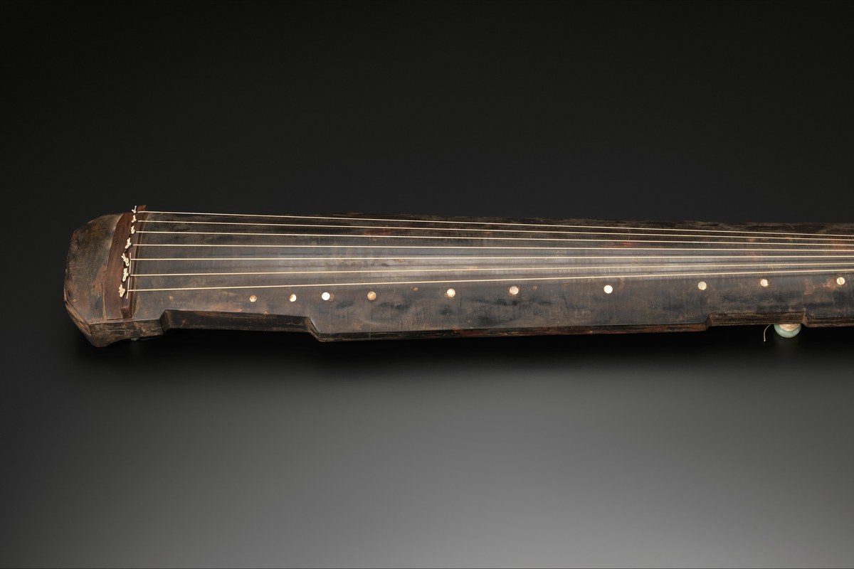 A guqin (古琴) — the ancient seven-string Chinese zither — from the Metropolitan Museum of Art, showing 7 strings and 13 hui position markers