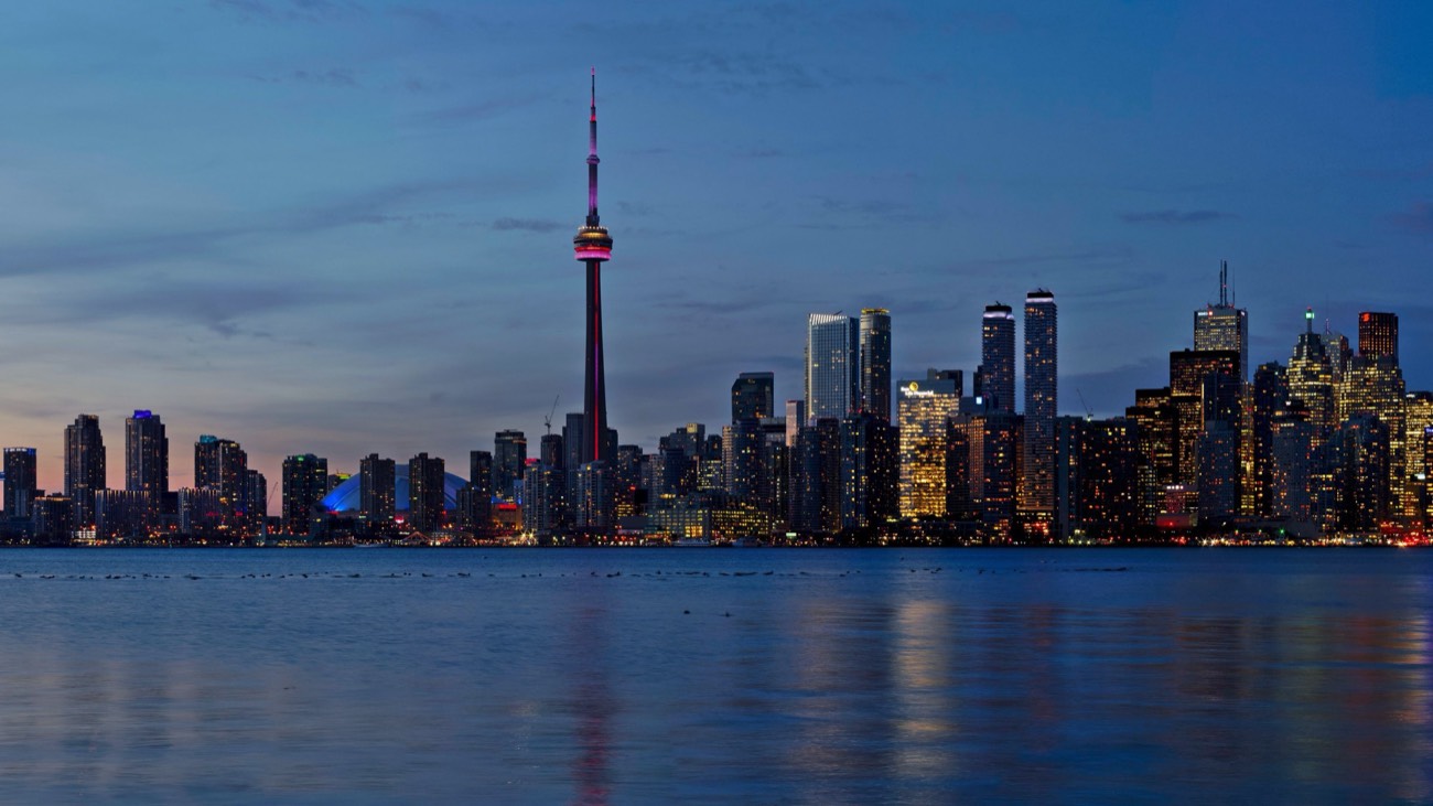 CN Tower and Toronto skyline at dusk over Lake Ontario — learn Mandarin online from Toronto with WillyChina