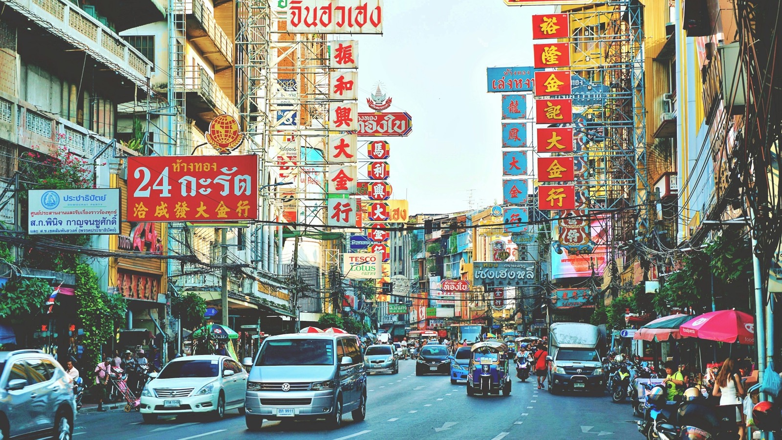 Yaowarat Road in Bangkok's Chinatown in the daytime, lined with Chinese-language signage and traffic — learn Mandarin online from Bangkok