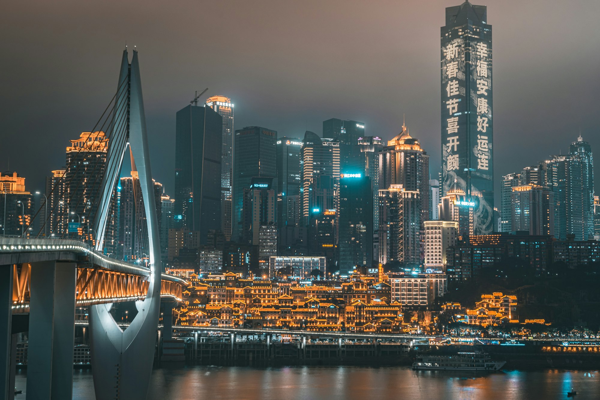 Chongqing&rsquo;s riverside skyline lit up at night above the Yangtze