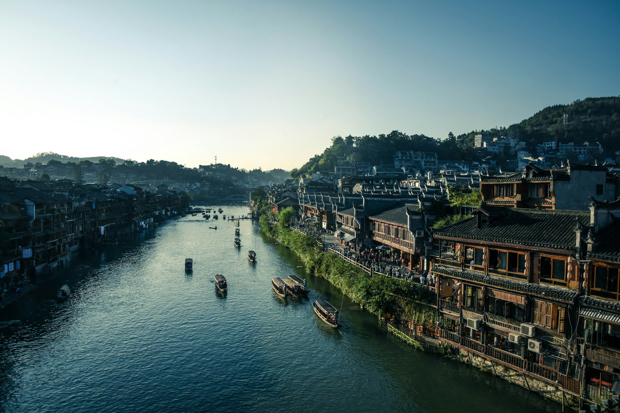 Aerial view of wooden boats moored beside riverside houses in Hunan, China