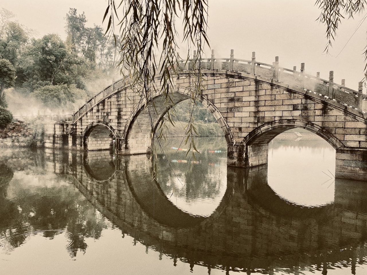 Stone arch bridge reflected in calm water near Yueyang, Hunan