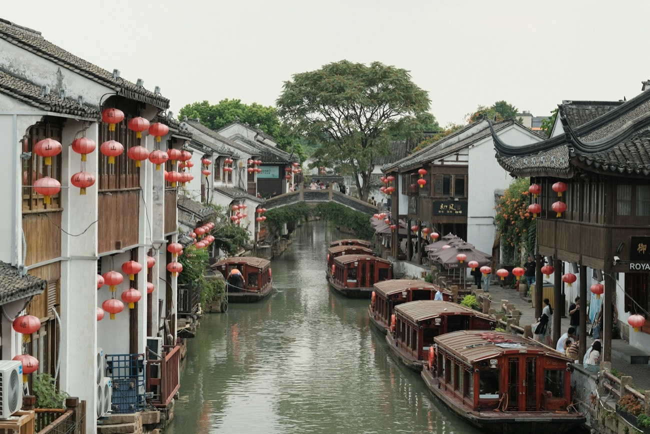 Boats moored along a canal lined with traditional buildings, Suzhou
