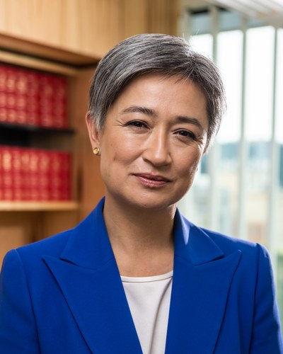 Official portrait of Senator Penny Wong in a blue jacket, taken for the Department of Foreign Affairs and Trade.