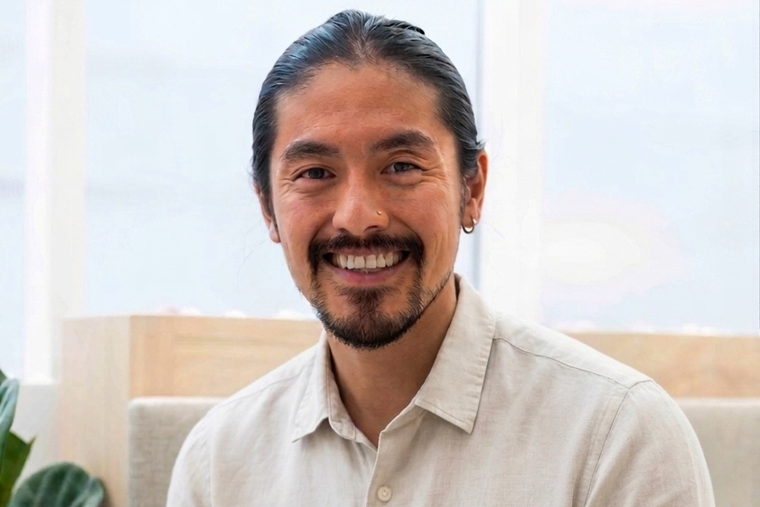 Will, the Mandarin teacher behind WillyChina, sitting and smiling in a bright room.