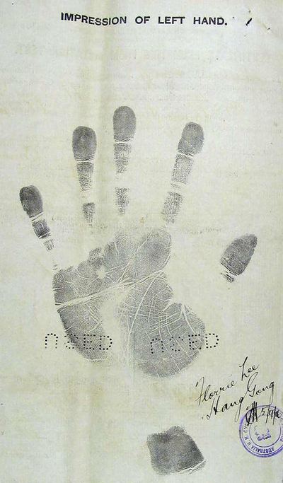 An impression of a woman's left hand on the reverse of a 1916 certificate exempting her from the dictation test, signed Florrie Lee Hang Gong.