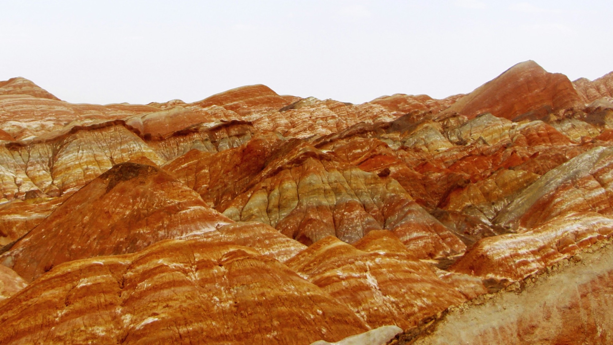 Zhangye Danxia rainbow mountains showing layered red, orange and yellow striated cliffs in Gansu, China