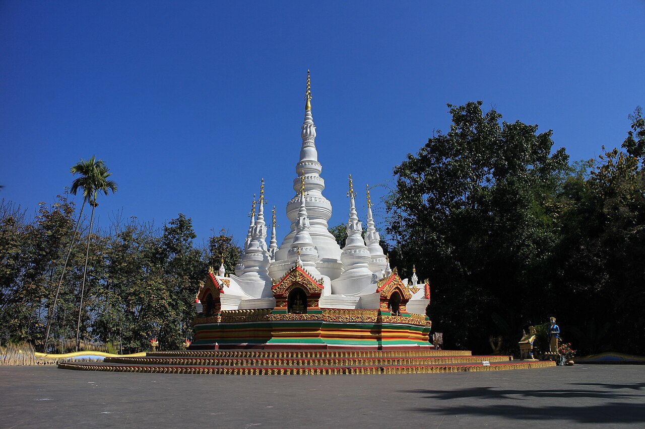 A gilded Theravada Buddhist Dai-style temple in tropical jungle, Xishuangbanna, Yunnan