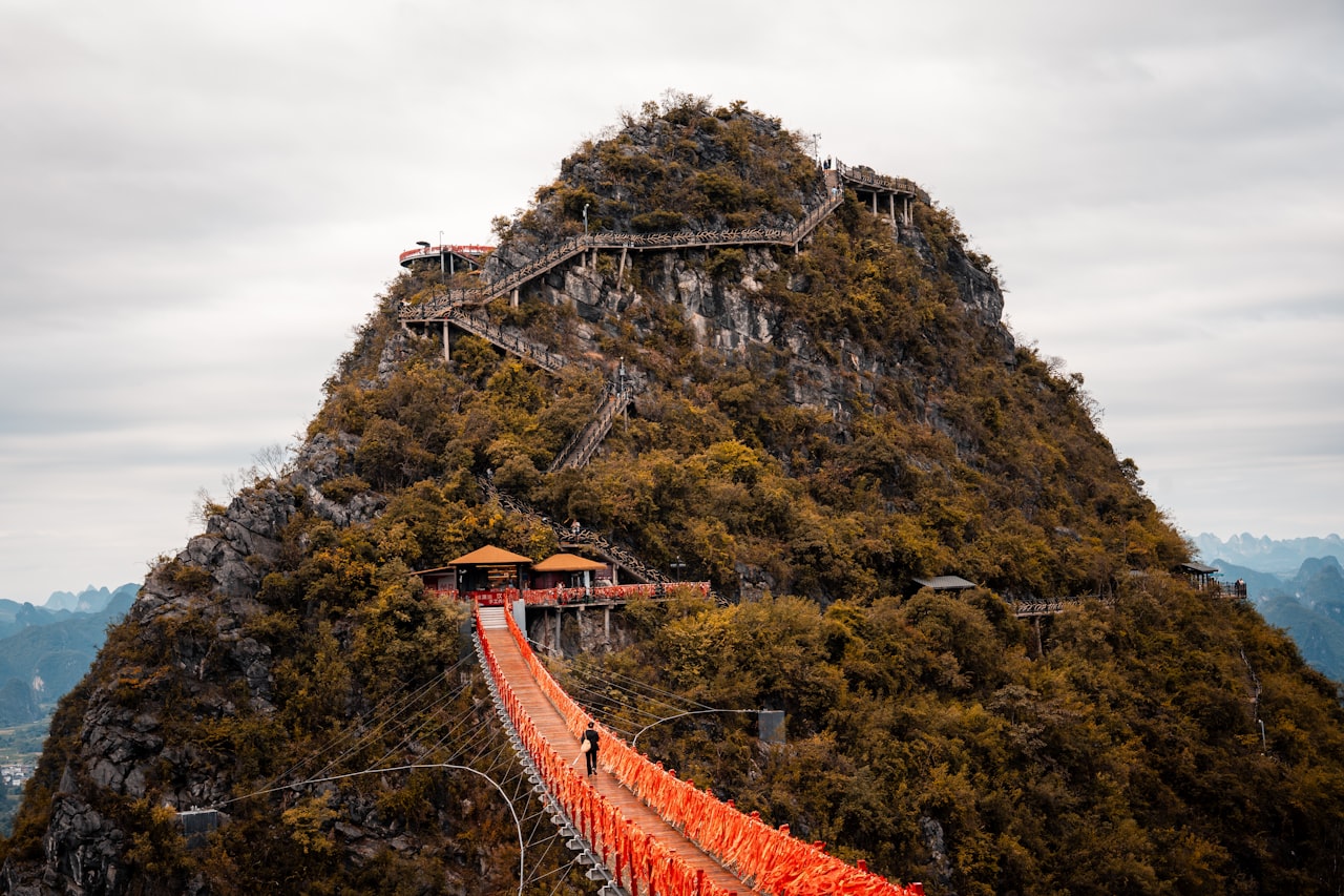 An arched bridge and stairs leading up a karst peak near Yangshuo, Guangxi