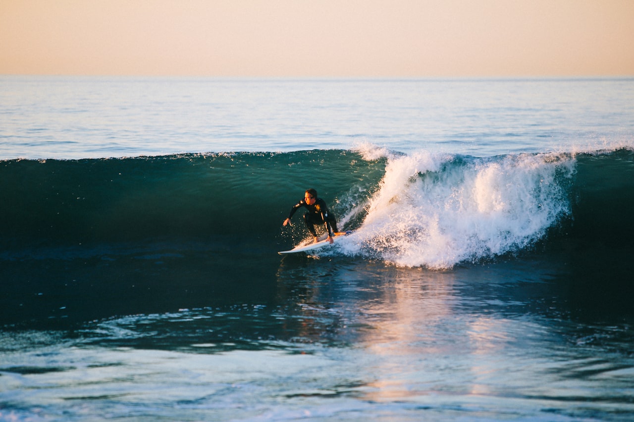 A surfer riding an ocean wave by day, Wanning, Hainan