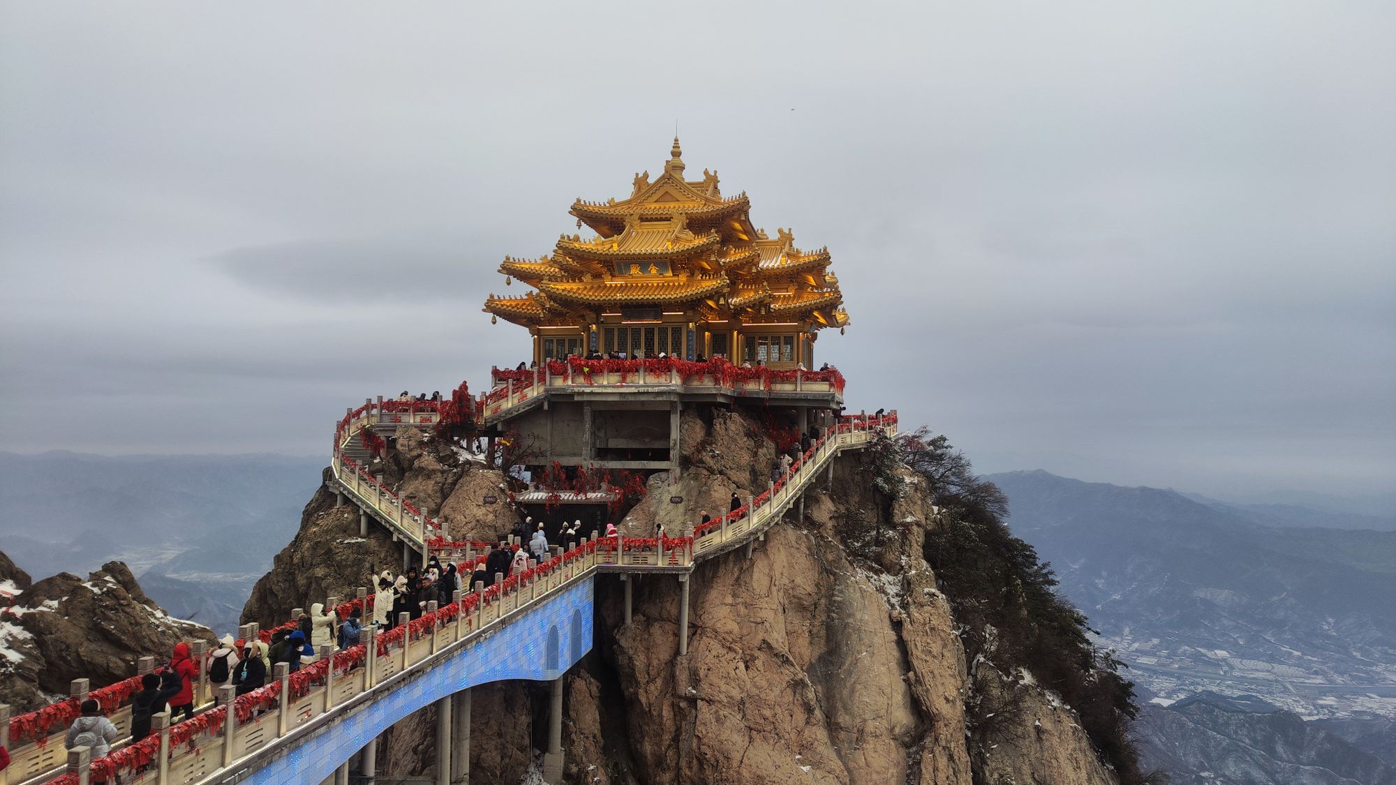 A golden summit temple wreathed in mist on a sacred mountain peak in Shandong