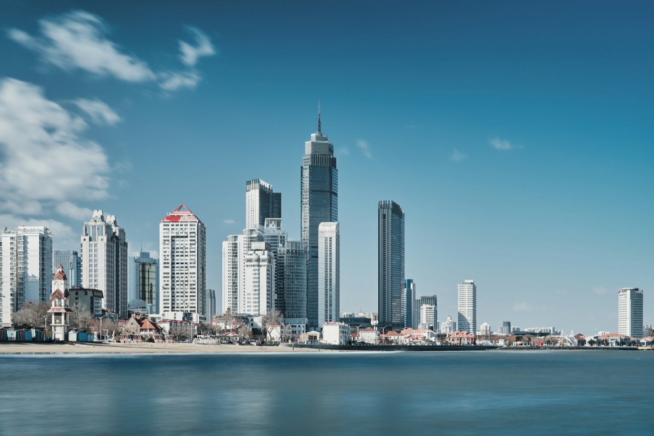 Yantai's modern skyline rising along the coast, seen across the water, Shandong