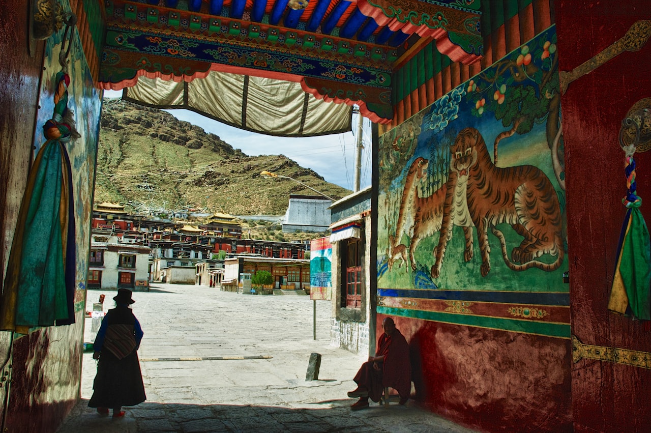 A colourful passage leading to monastery buildings and mountains, Shigatse, Tibet