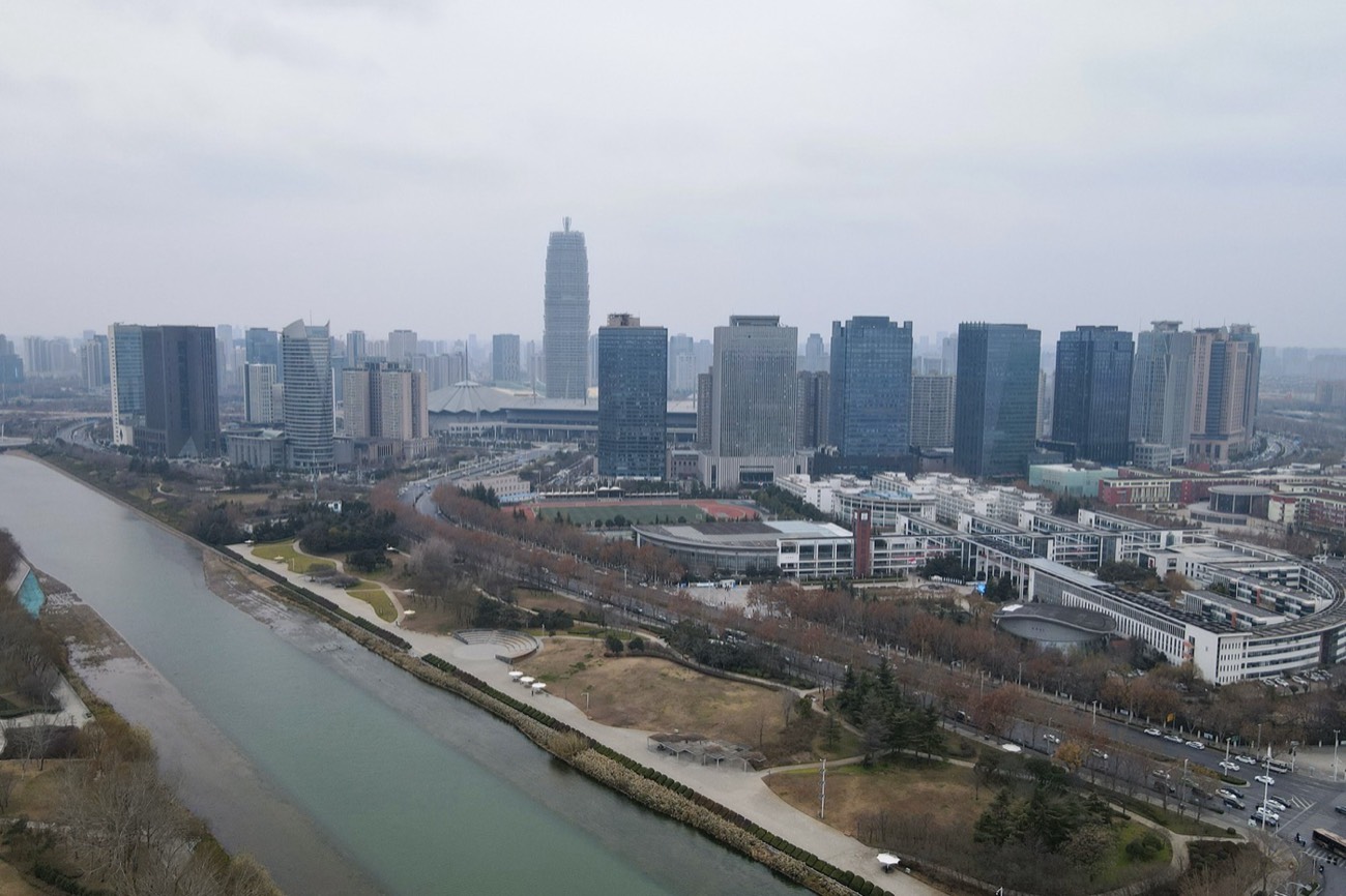 The Zhengdong New Area CBD skyline rising beside the water in Zhengzhou, Henan